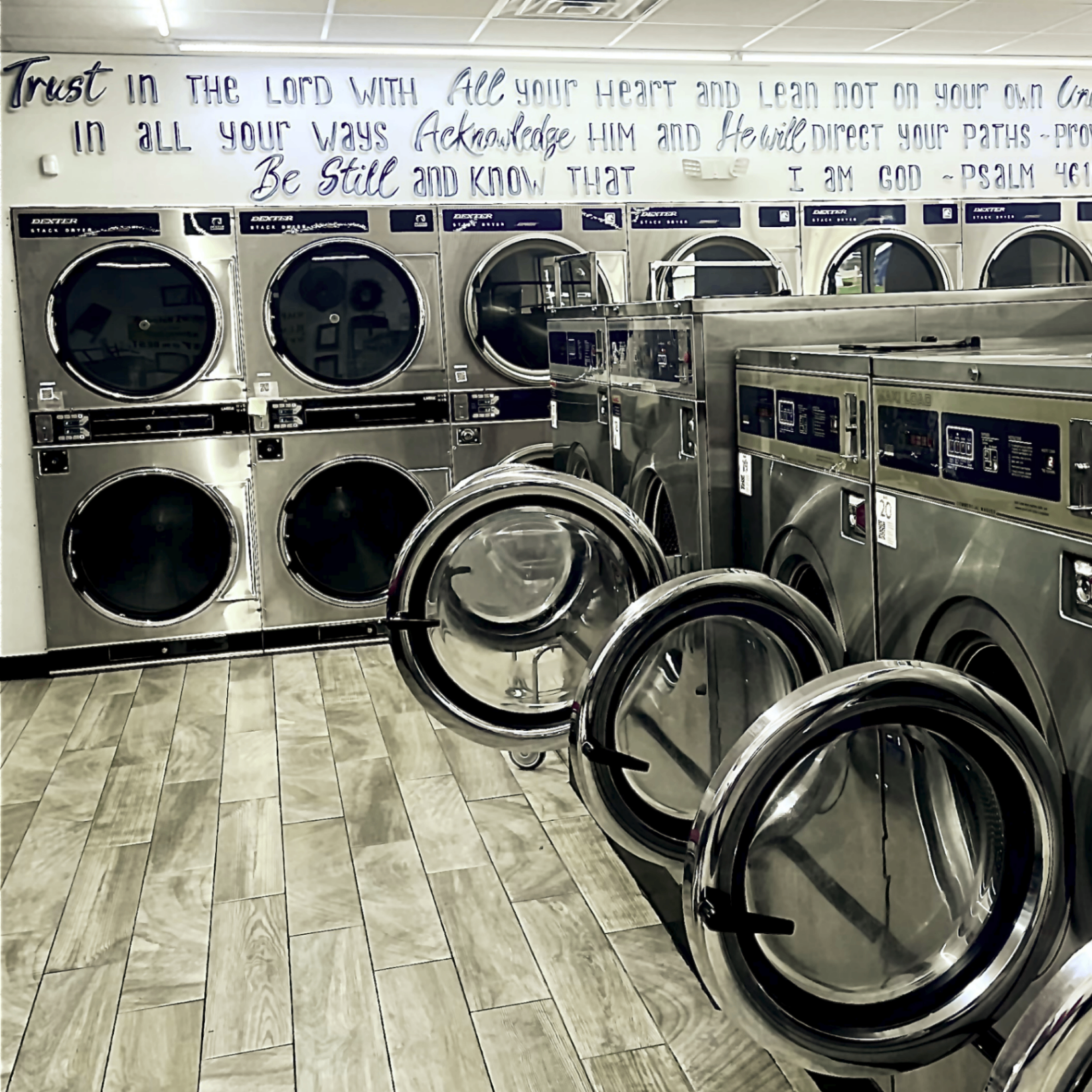 Rows of Dexter stack dryers and Maxi Load washers inside The Missing Sock Laundromat